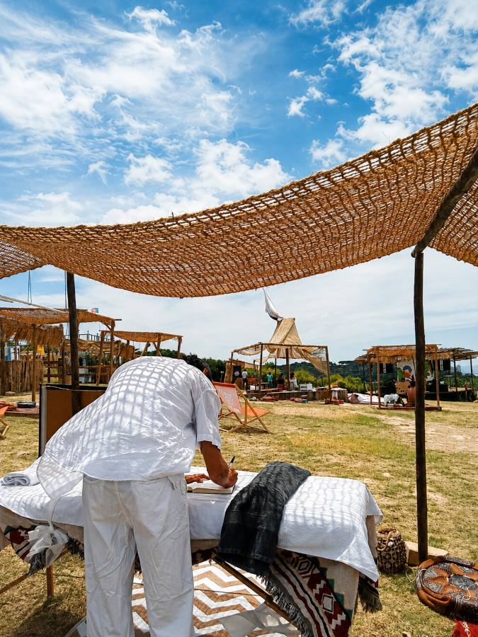Tomás setting up his massage table at an outdoor retreat